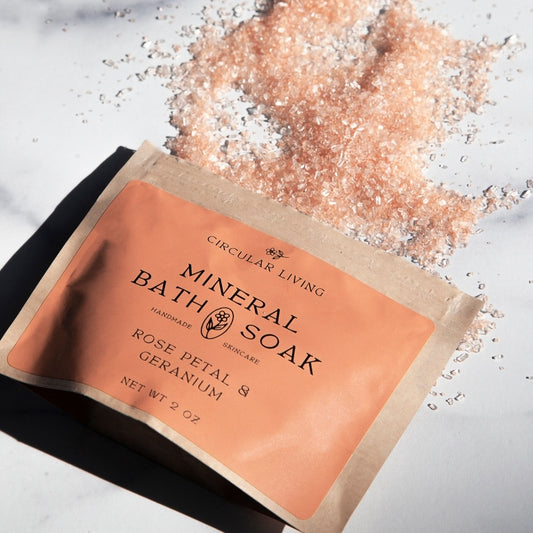 Mineral bath soak package with rose petal and geranium scent on a light background