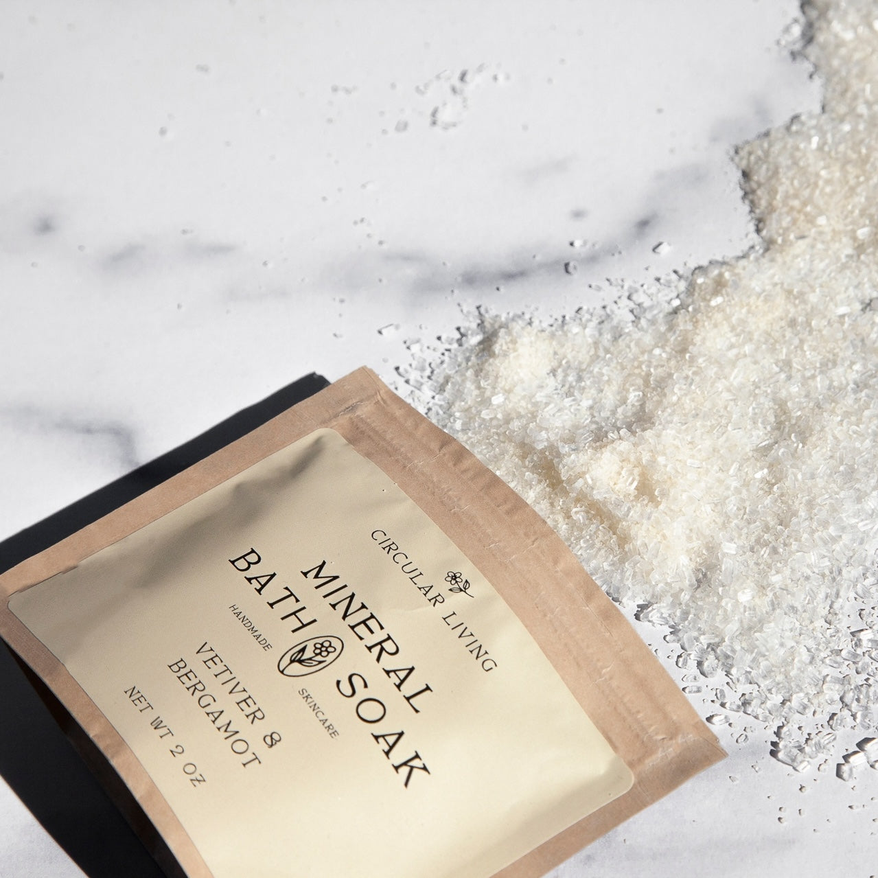 Bath mineral soak package on a marble surface with bath salts.