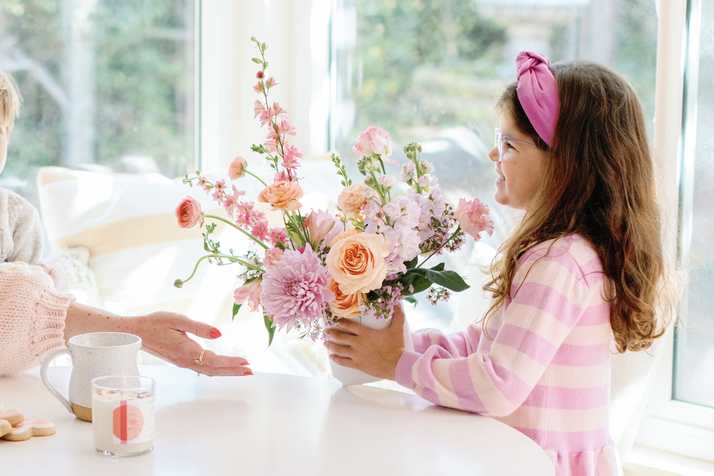 Child gifts pink and peach flower arrangement for Mother's Day to mom