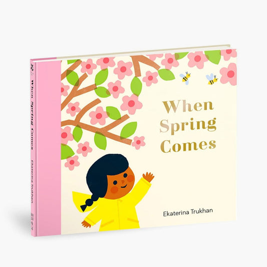 Children's book titled 'When Spring Comes' with a cover illustration of a child in a yellow raincoat and cherry blossoms.