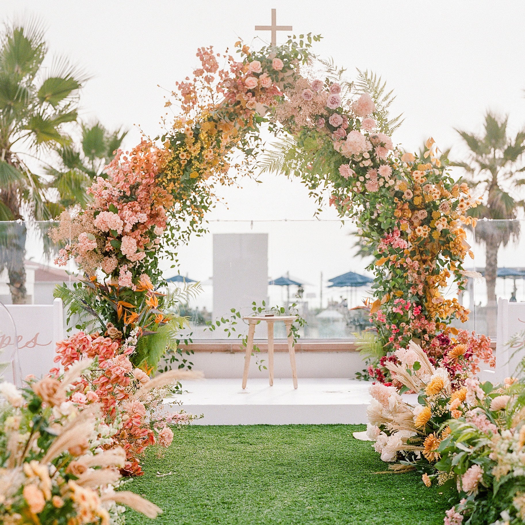 Native Poppy full service floral design for weddings featuring arch decorated with fresh and dried flowers