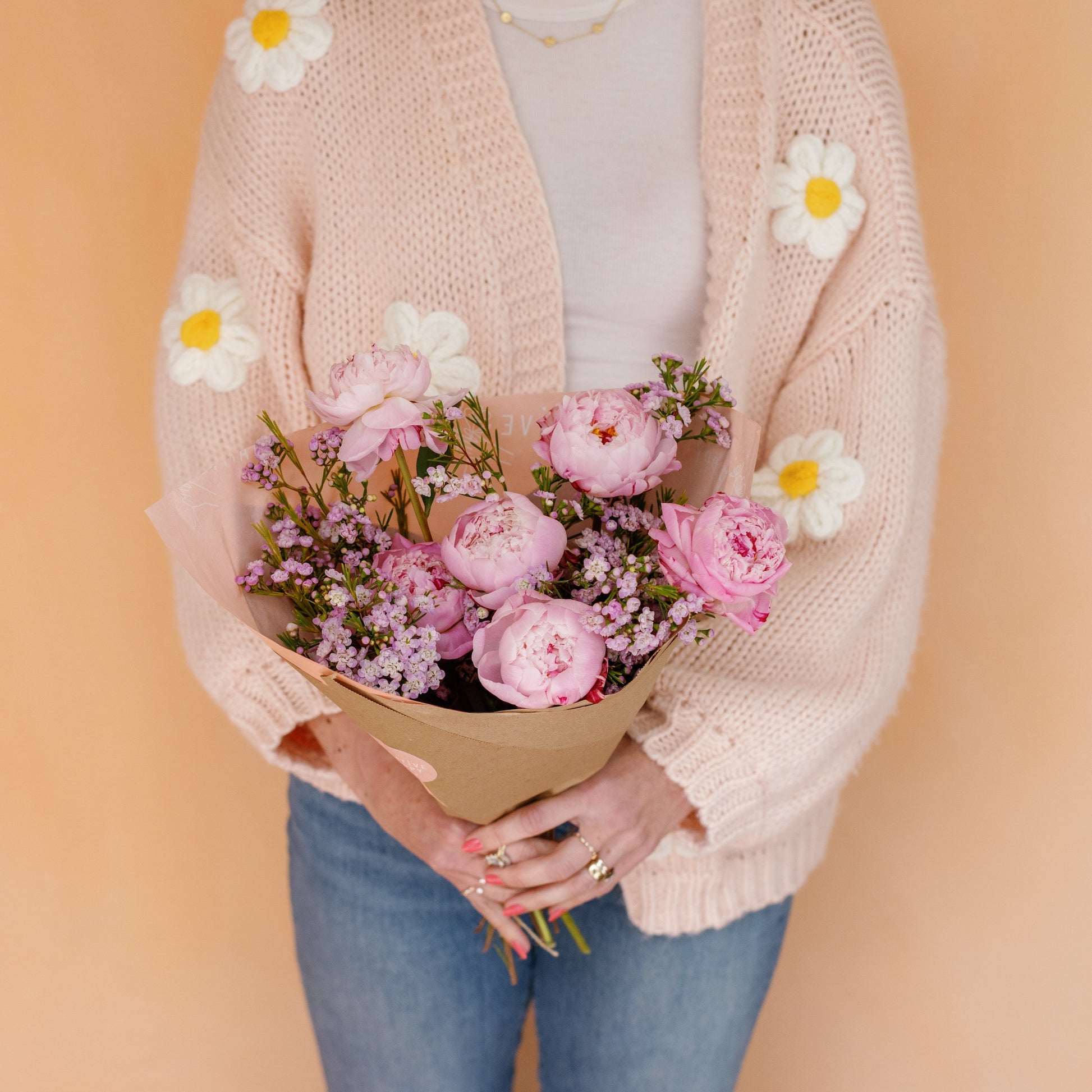Woman holding Peonies wrapped in paper for Mother's Day