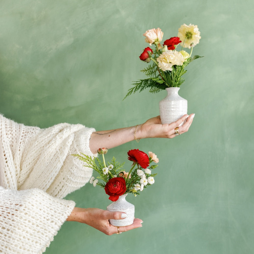 Holiday Bud Vase Arrangements held in Meg's hand