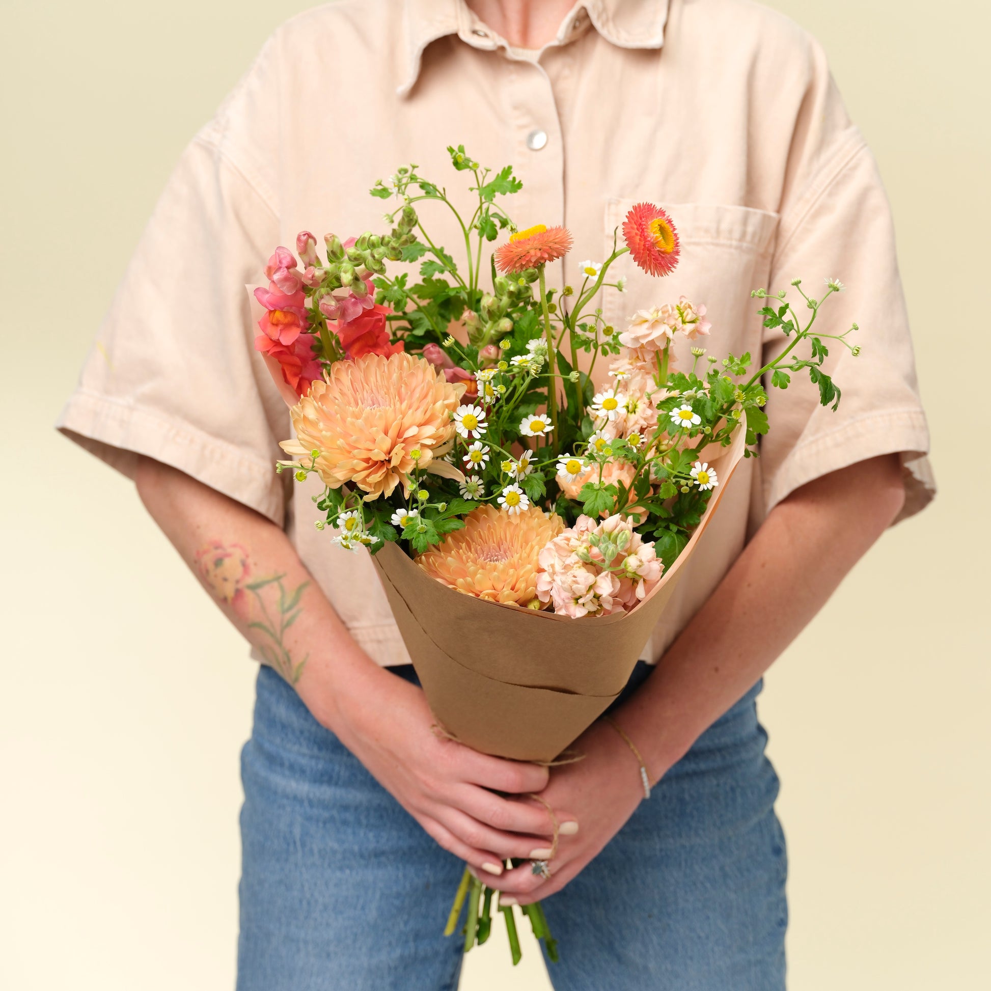 Petite bright + cheery flower wrap held by a woman