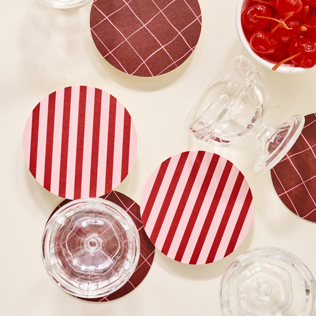 red and pink striped coasters with glasses and cherries