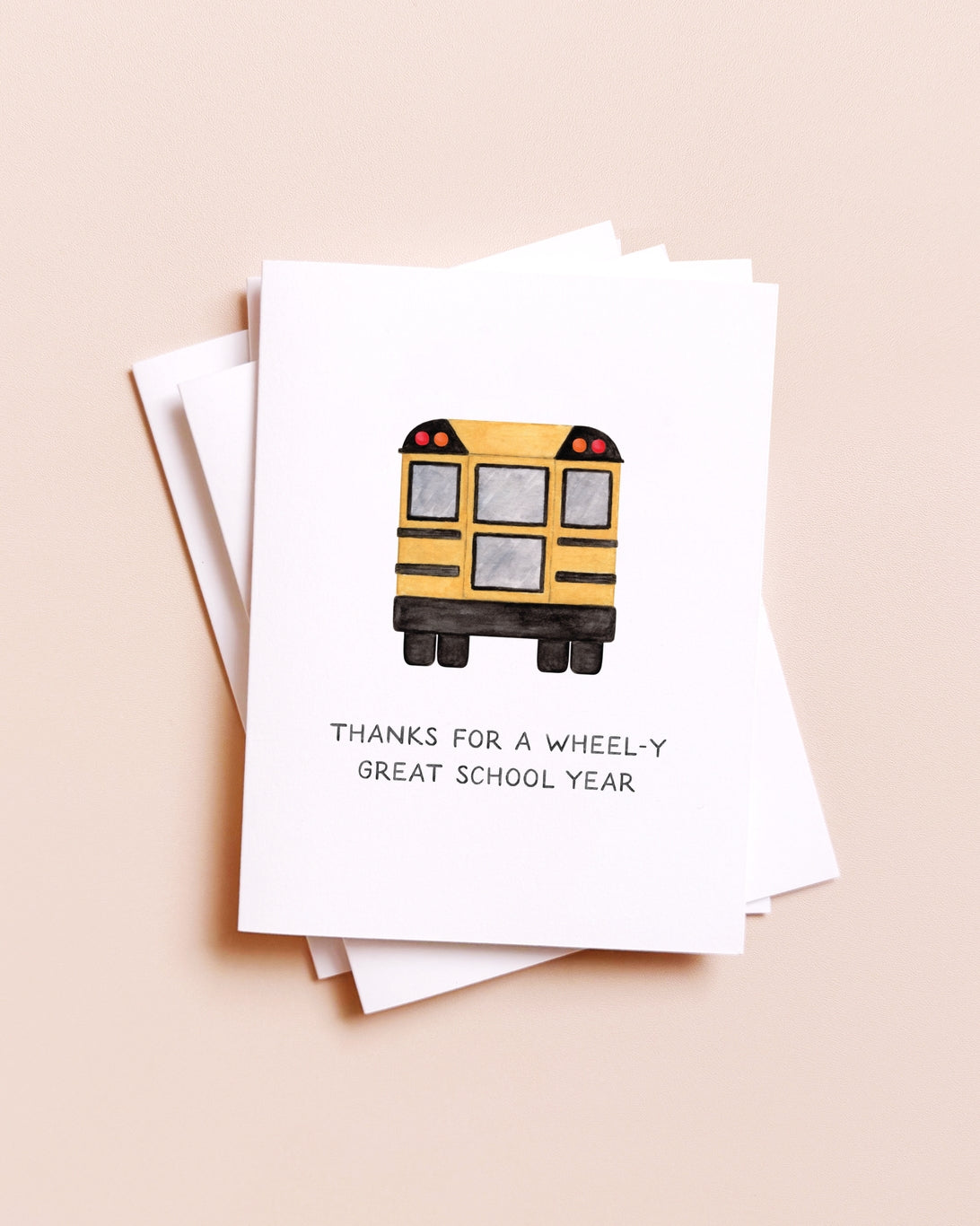 Card with a school bus illustration and text on a beige background