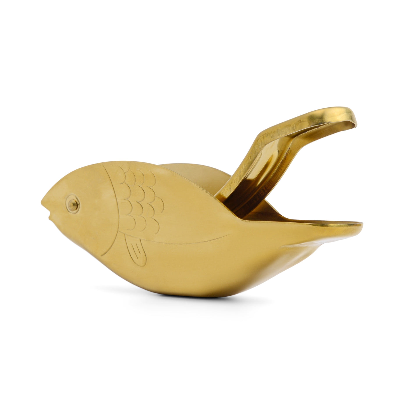 Gold fish-shaped citrus juicer on a white background