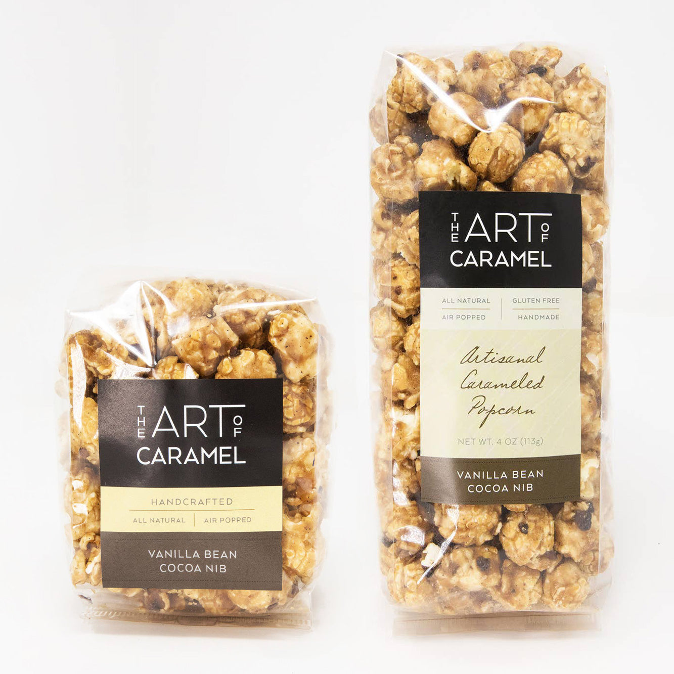 Two packages of 'The Art of Caramel' vanilla bean cocoa nib popcorn on a white background.