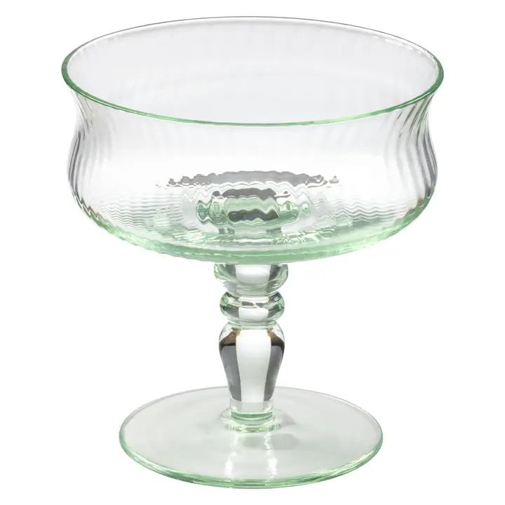 A little vintage charm for your next pour. This mint-hued coupe brings a softly nostalgic feel to the table, with delicate ribbed glass and a sculptural stem that feels collected rather than ordinary.