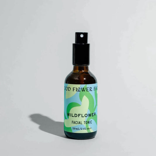 Bottle of Wildflower Facial Tonic with a green label on a light gray background