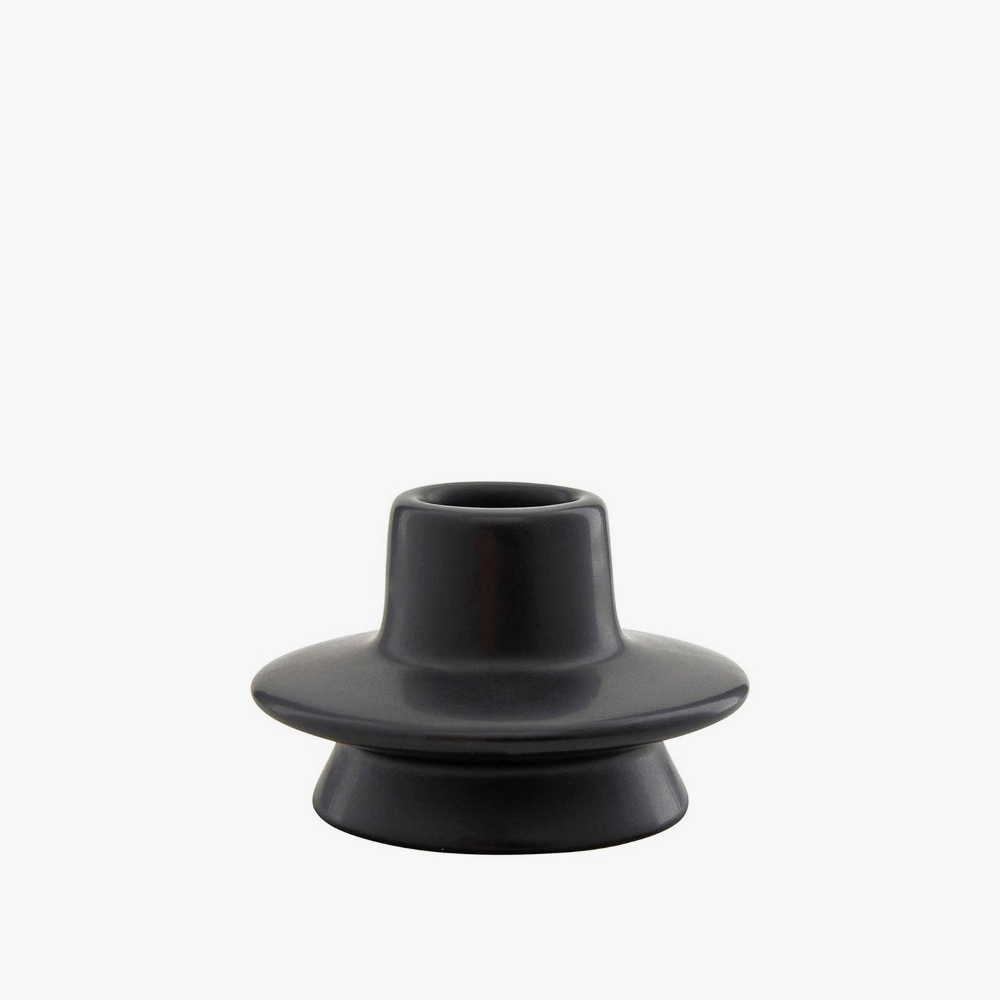 Short black candle holder on a white background