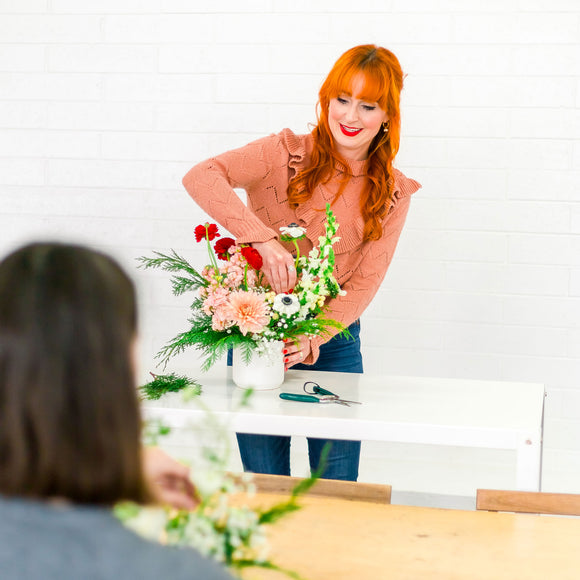 Meg teaches student to make a flower arrangement