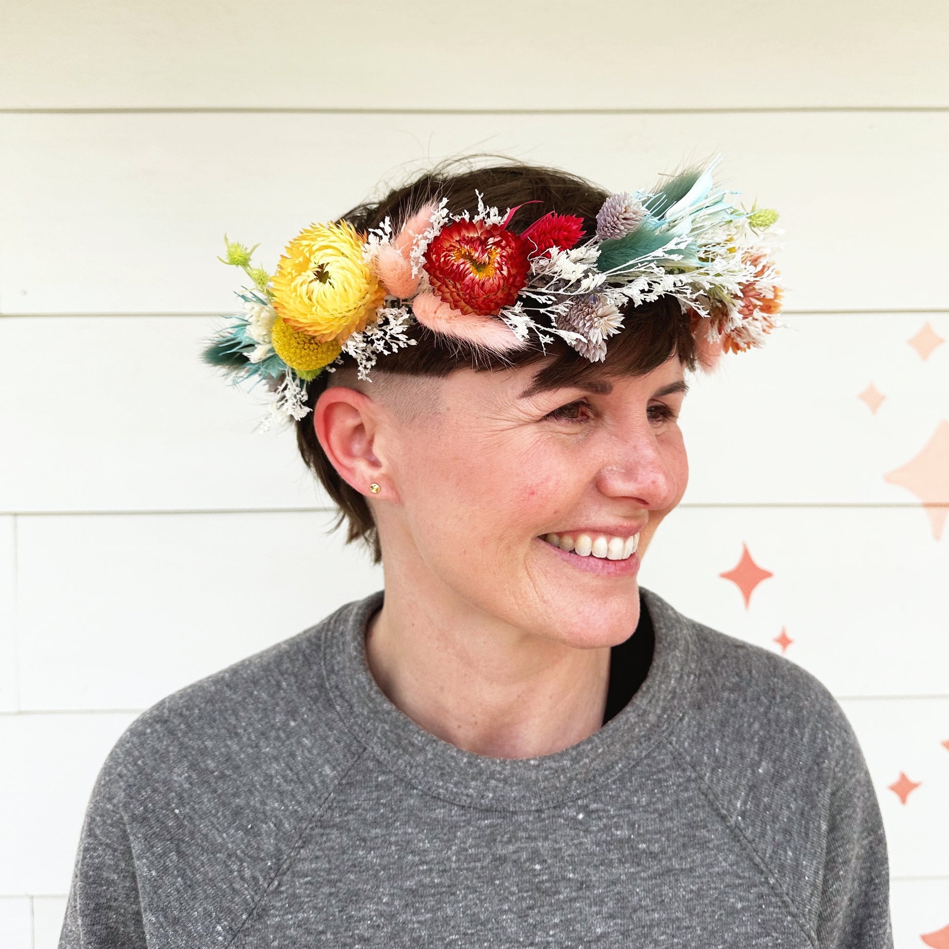 Native Poppy florist Jesse wearing rainbow dried flower crown