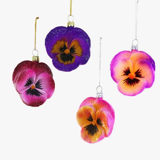 four colorful pansy flower ornaments on a white background