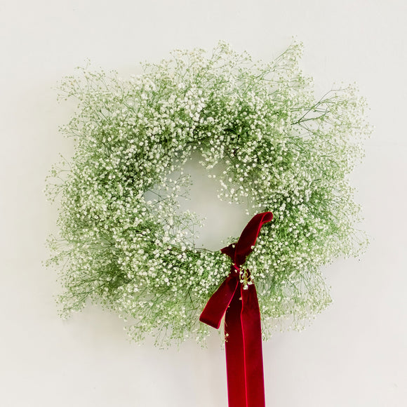 Snowball Blooms Wreath made of baby's breath tied with red velvet ribbon