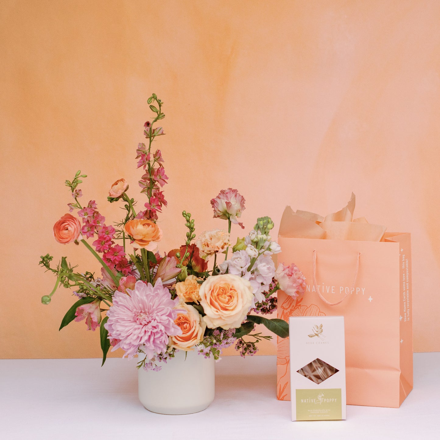 Mother's Day flowers and chocolate bar with peach gift bag
