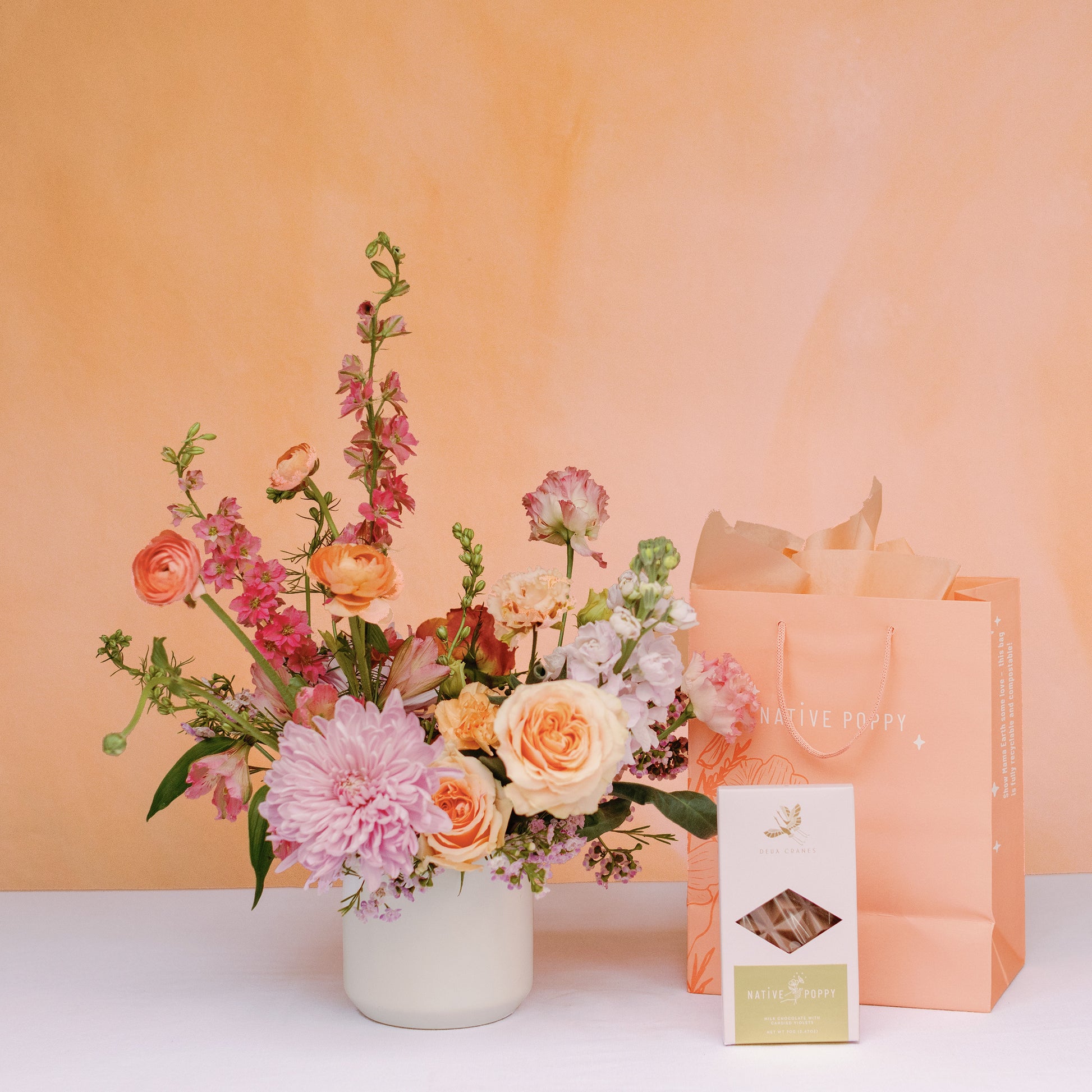 Mother's Day flowers and chocolate bar with peach gift bag