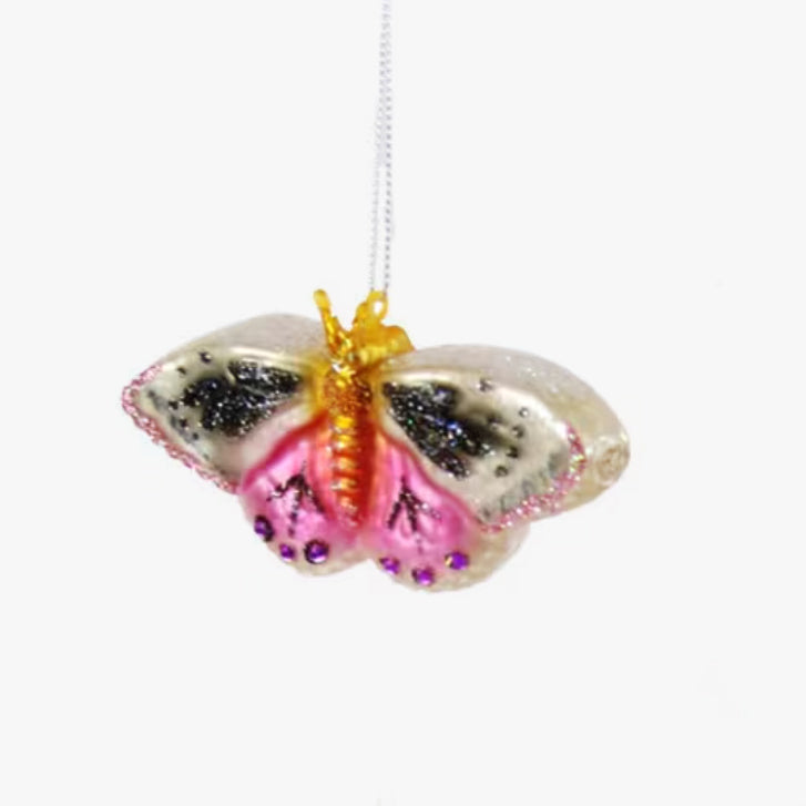 Butterfly-shaped ornament with pink and gold details on a white background