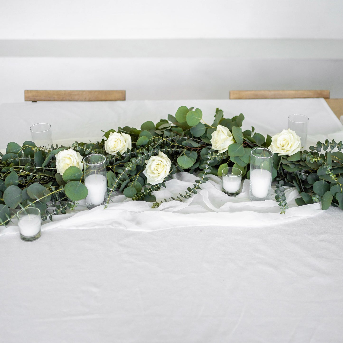 Eucalyptus Garland with white roses with votive candles