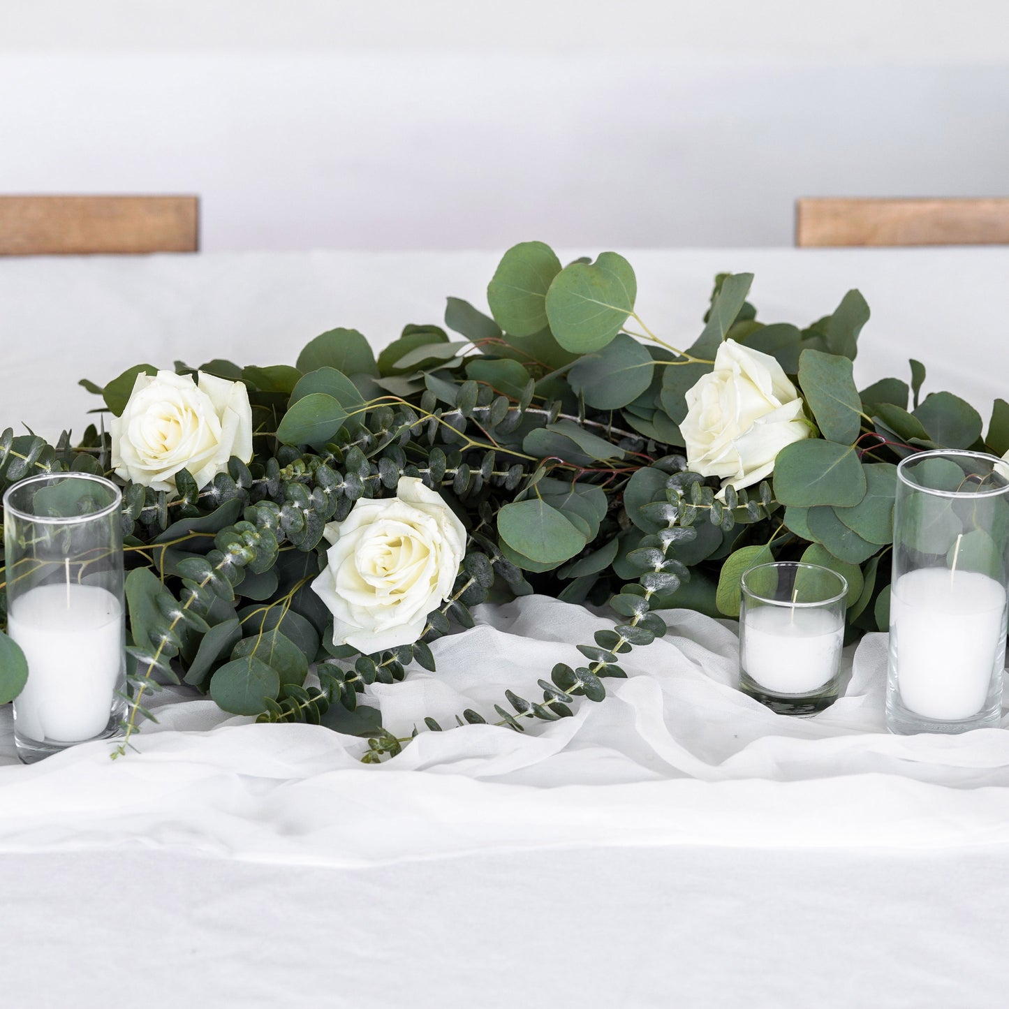 Eucalyptus Greenery Garland with white roses with votive candles