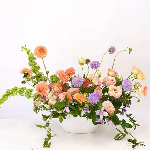 Lush Garden Flower Arrangement in a white ceramic long + low vase