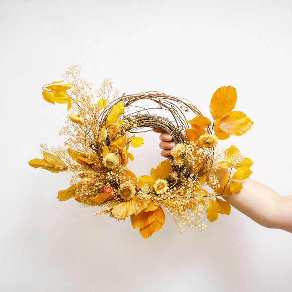 Gold and tan autumn wreath on grapevine