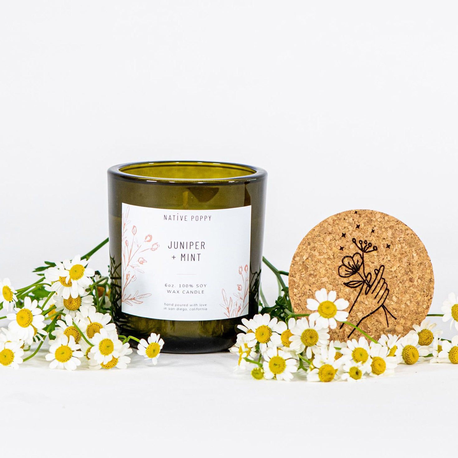 Native Poppy Signature Candle - Juniper & Mint scent in green glass jar with cork top