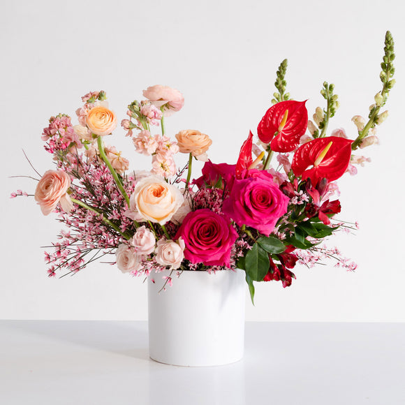 Large Valentine's Day flower arrangement in shades of pink, red, and peach