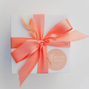Native Poppy Gift Wrap - peach satin ribbon and dried flowers on branded box