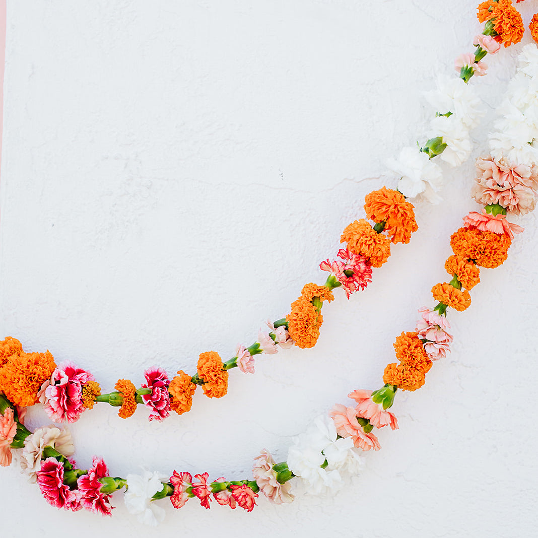 Orange, pink, and white carnation and marigold garlands