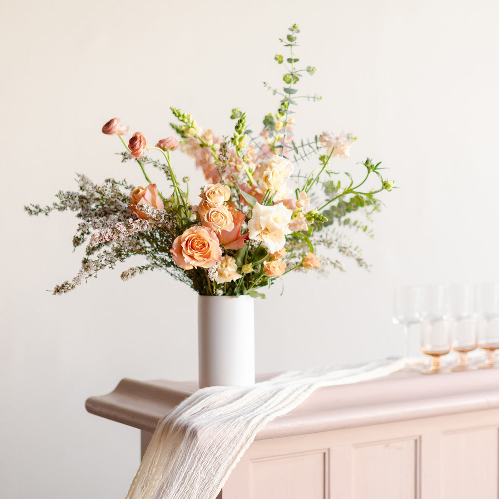 Tall flower arrangement on a wedding bar