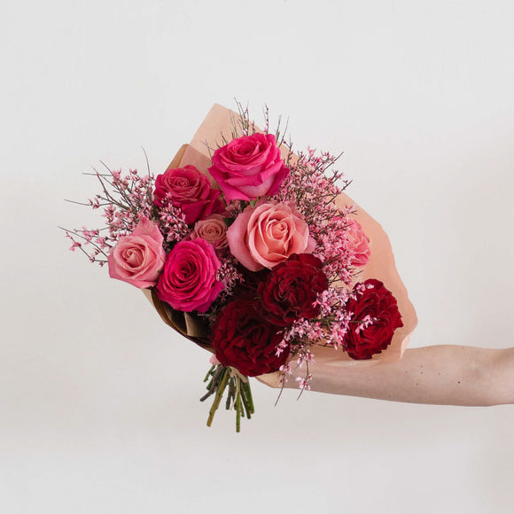Wild heart garden roses and mini pink textural flowers wrapped in paper