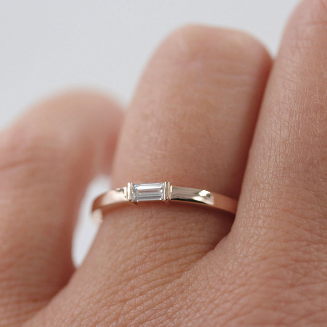 Rose gold baguette diamond ring worn by model