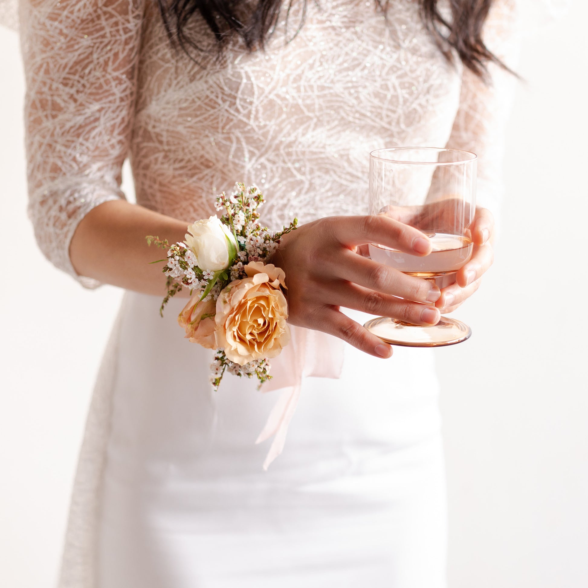 Floral wrist corsage worn by a bride