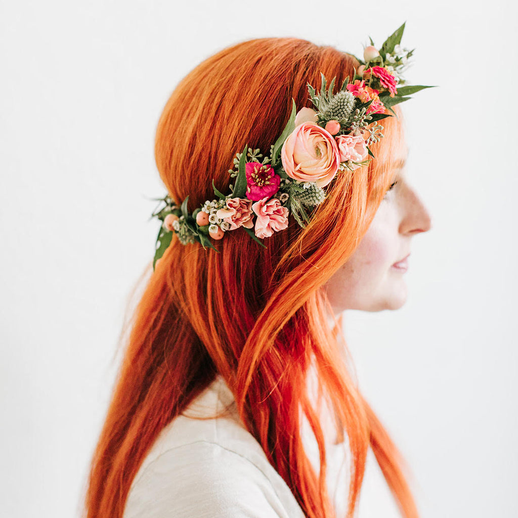 Woman with red hair wearing a flower crown