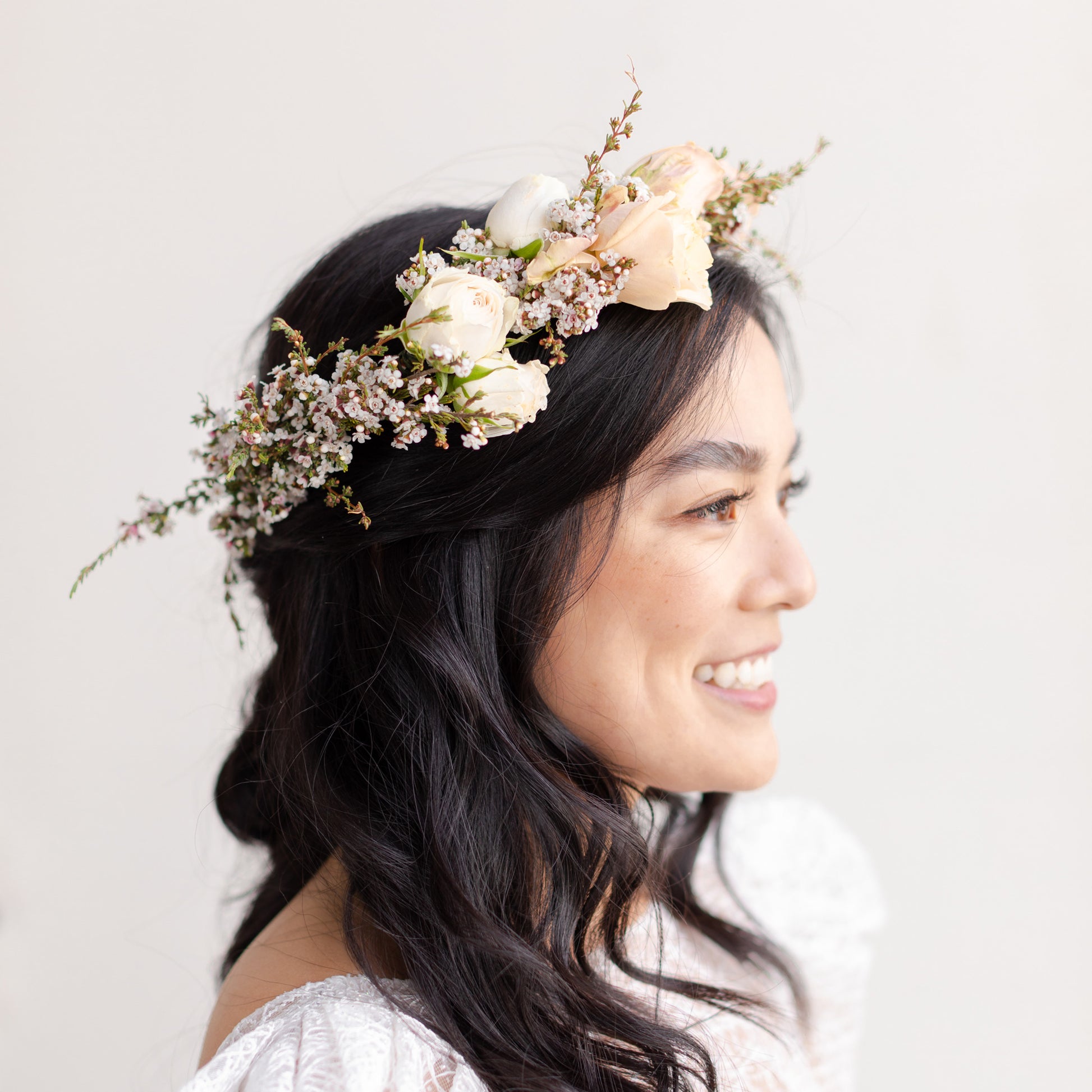 Woman with dark hair wearing Grace flower crown from Native Poppy