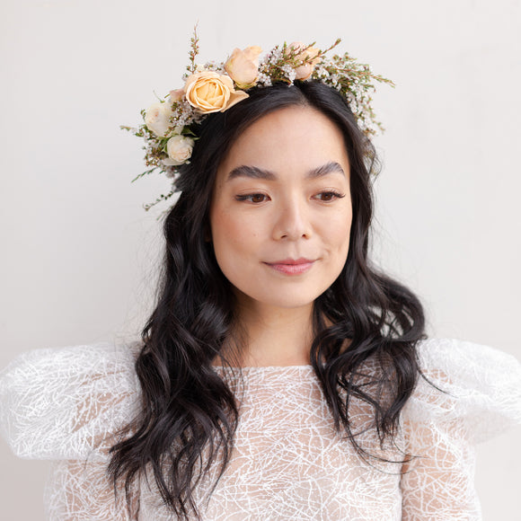 Woman with dark hair wearing Grace flower crown from Native Poppy