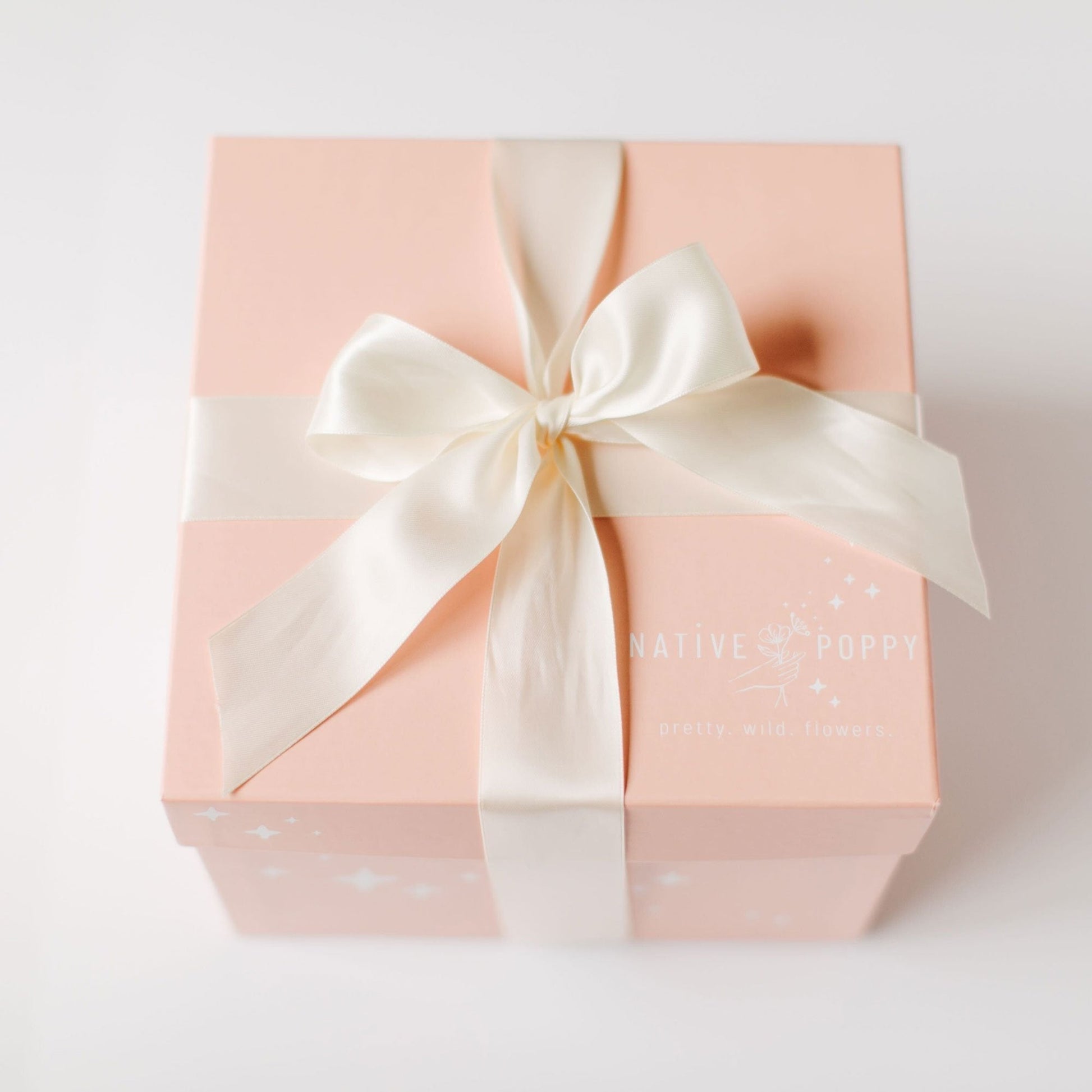Peach gift box with white satin ribbon