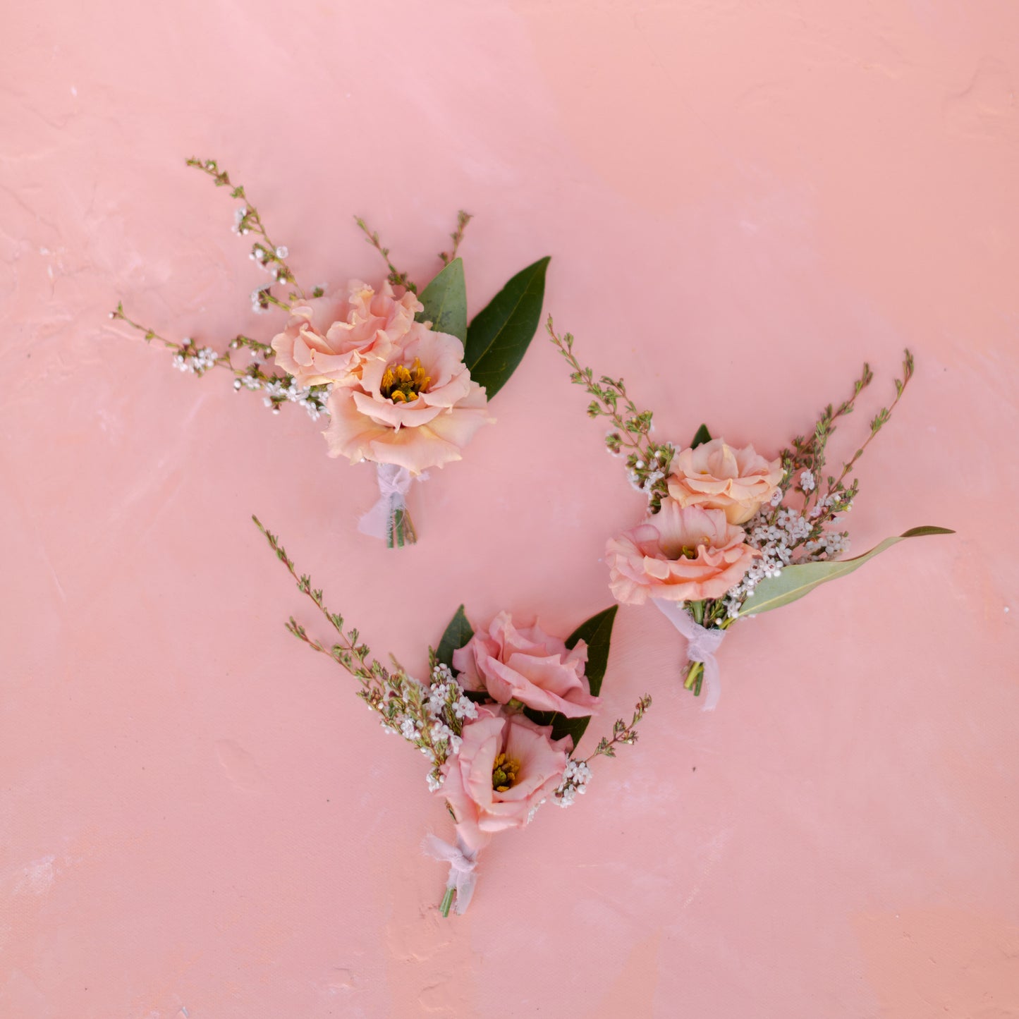 Selection of peach pink toned floral boutonniers