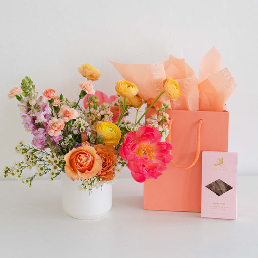 Mother's Day flowers and chocolate bar with peach gift bag