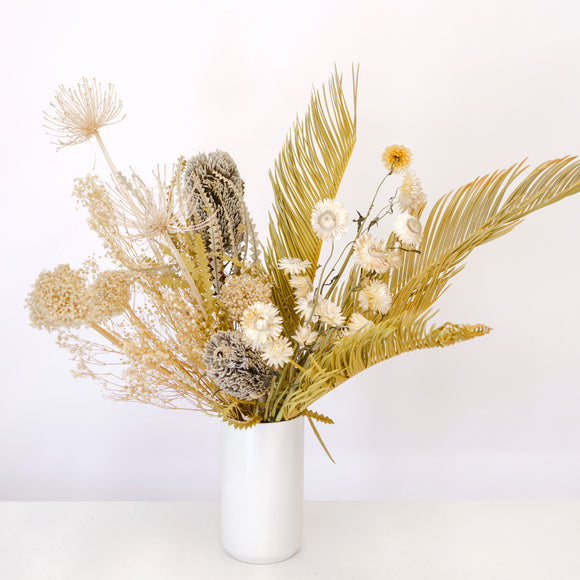 Tall sculptural dried flower arrangement in neutral colors